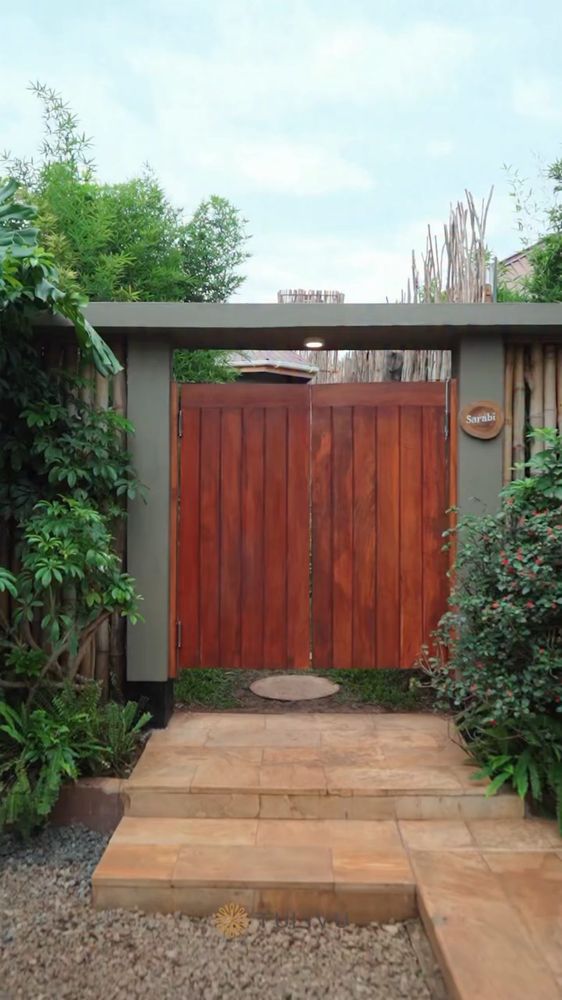 Timber, stone and planting at the entrance.