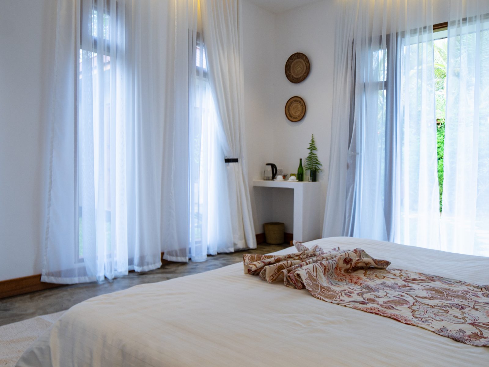 Guest suite with the garden beyond the curtains
